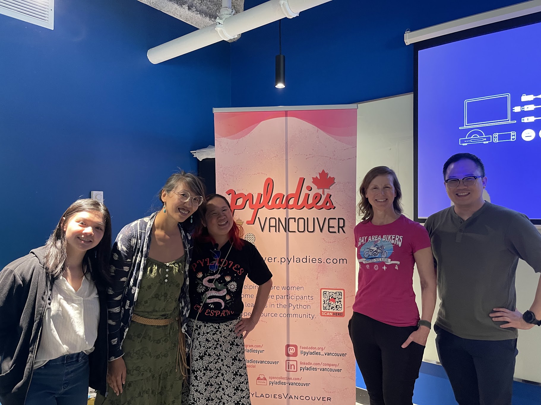 Five people smiling in front of the PyLadies Vancouver banner, including speakers Melanie Warrick and Daniel Chen